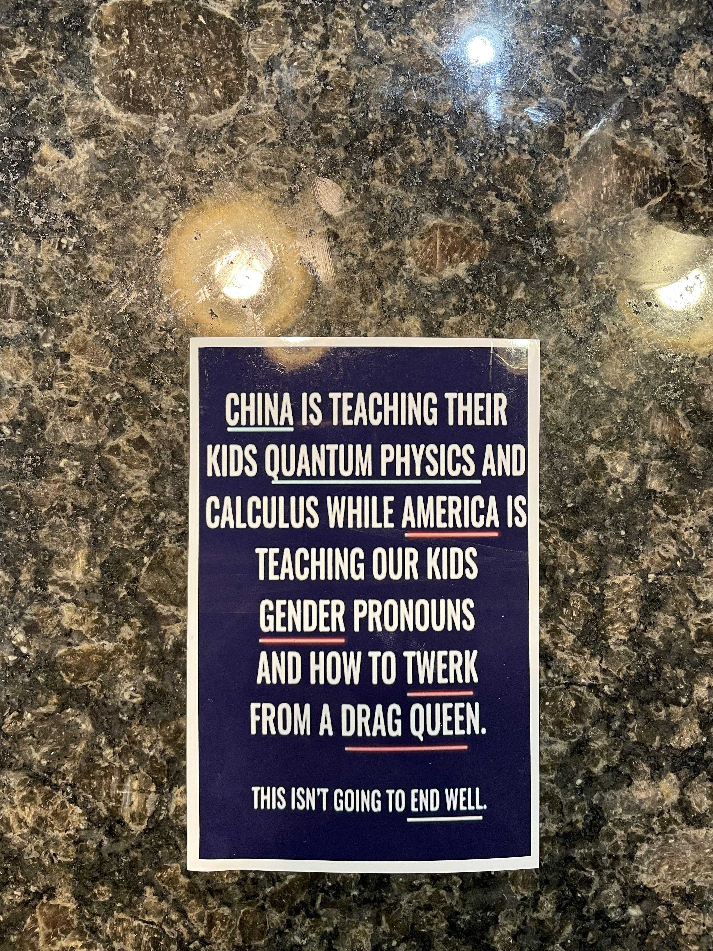 there is a sign on the wall that says china is teaching their kids quantum physics and calculus while america is teaching our kids gender pronouns and how