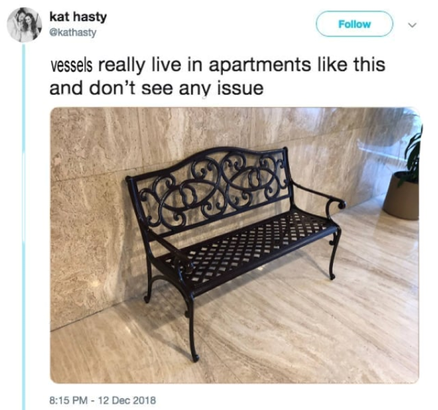 a close up of a bench on a tiled floor near a wall