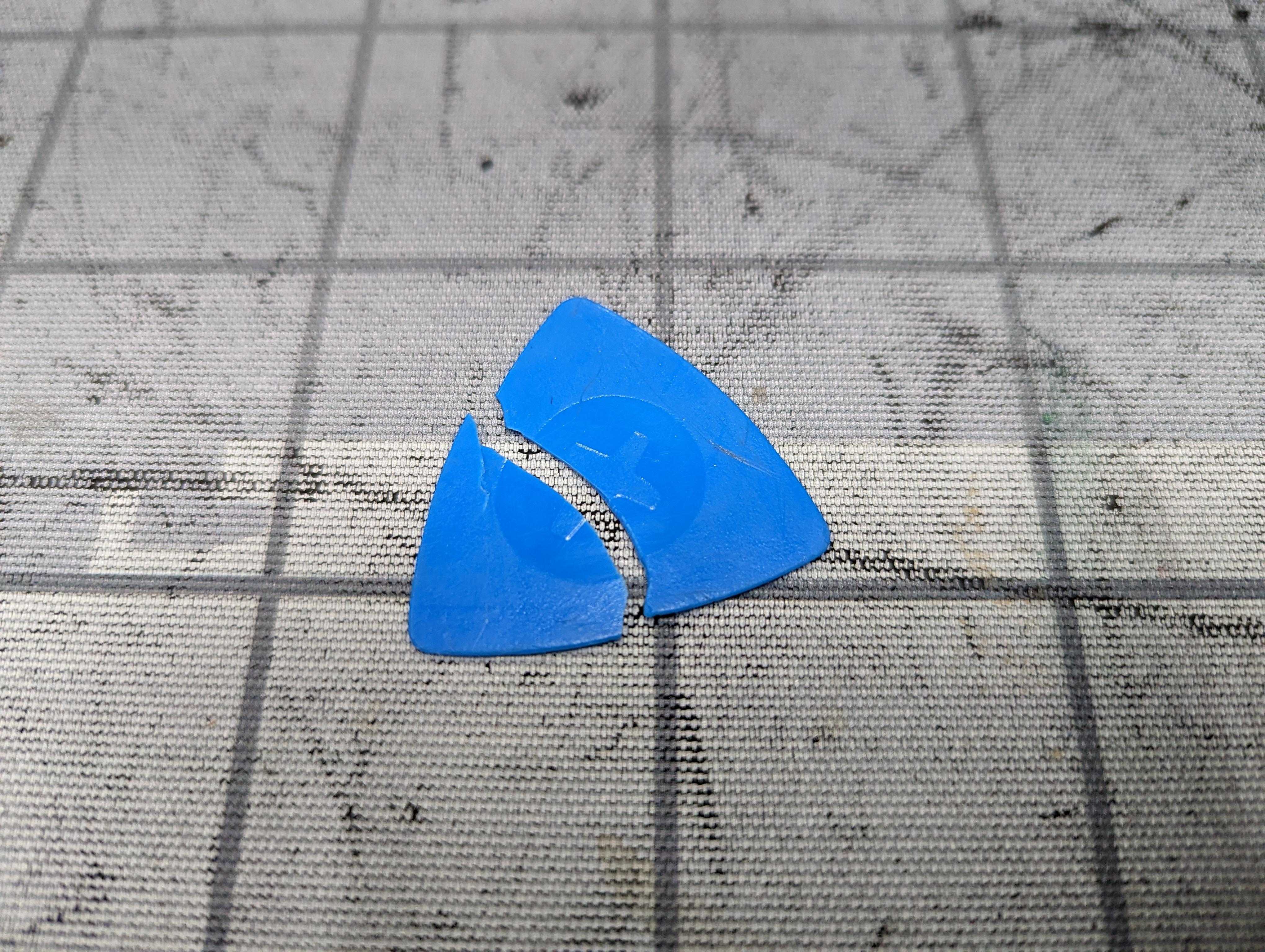 there is a broken blue piece of plastic on the ground