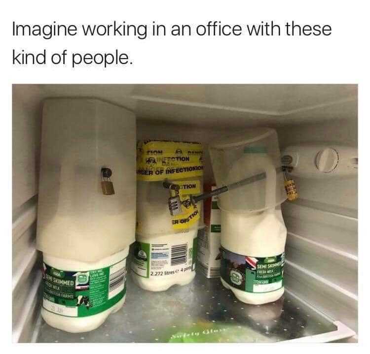 there are two bottles of milk in the fridge with a sign on the door