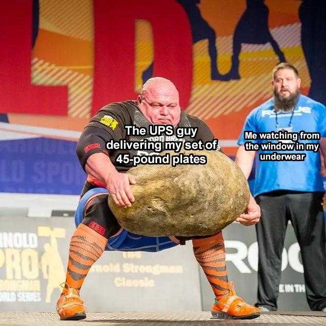 man holding a large rock in front of a man