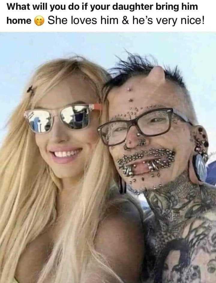 man with a tattooed face and a woman with piercings