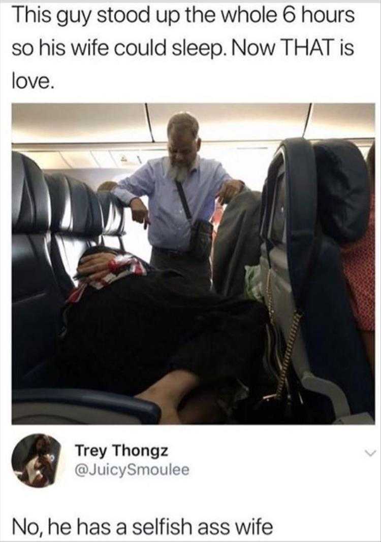 man sitting in a plane with a woman on his lap