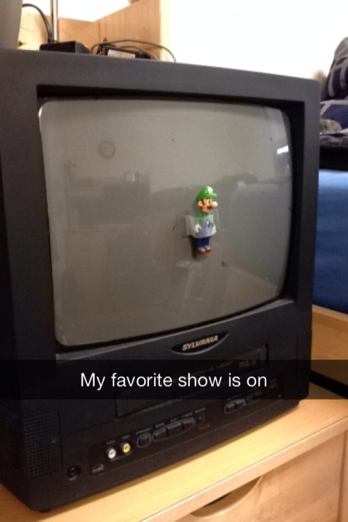 a close up of a television with a toy on top of it