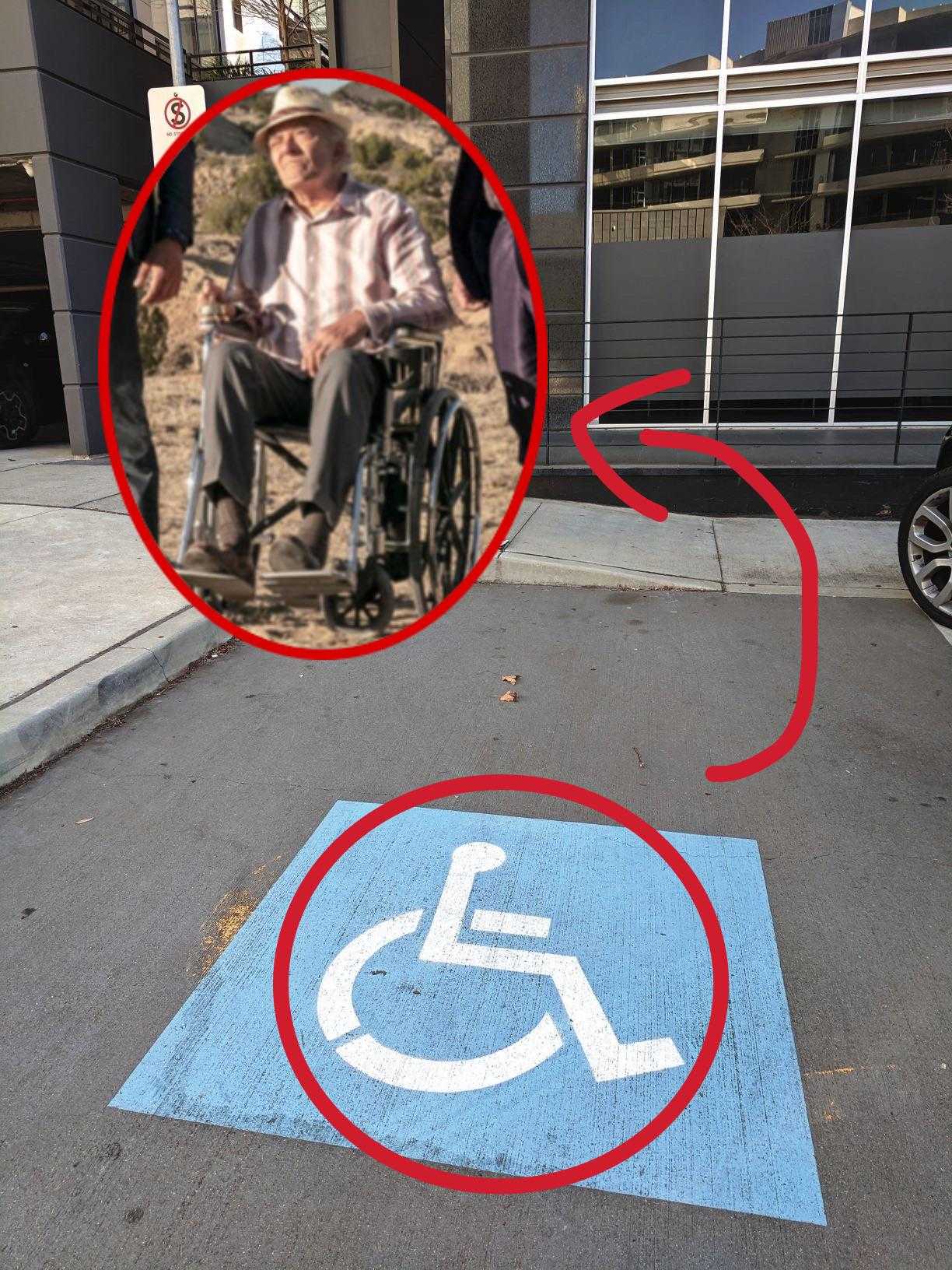 image of a man in a wheelchair in a parking lot