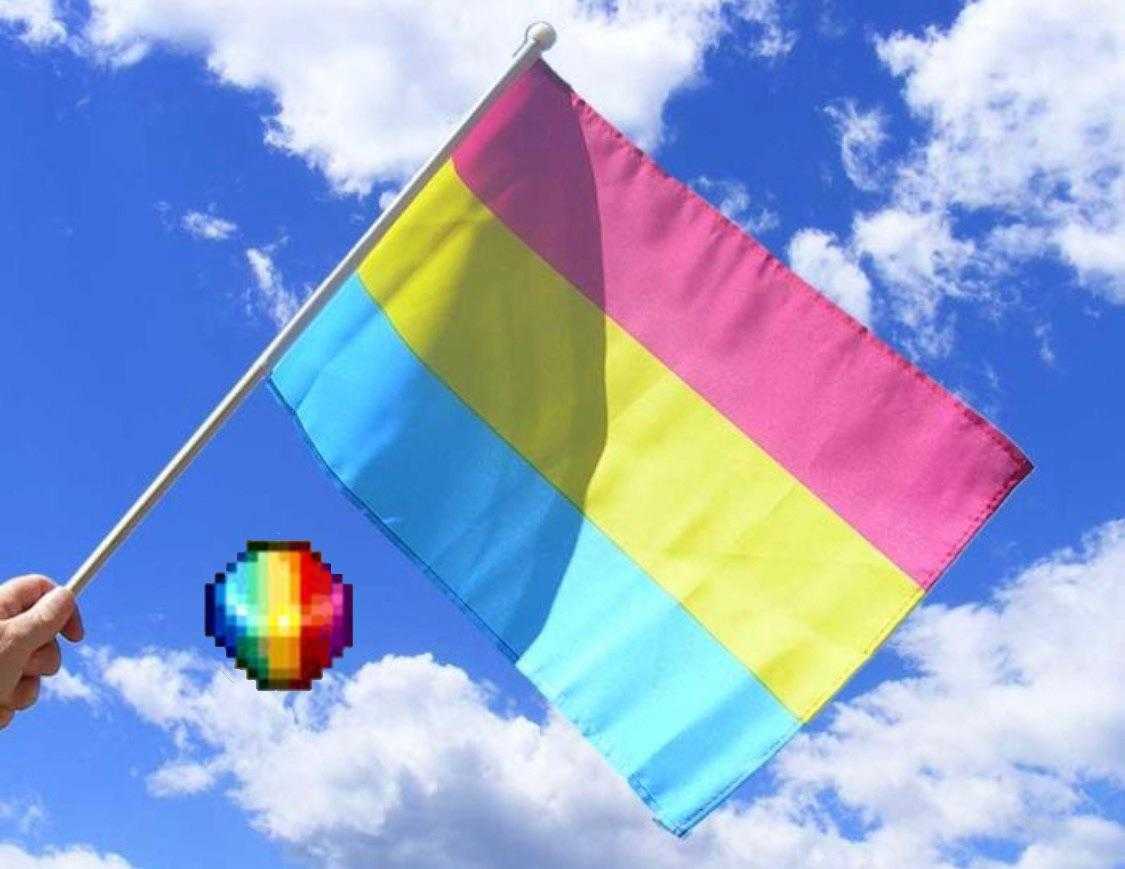 someone holding a rainbow flag with a heart on it