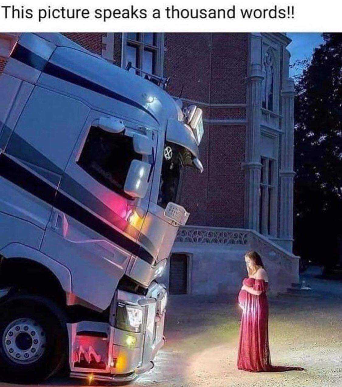 truck with a woman in a red dress standing in front of it