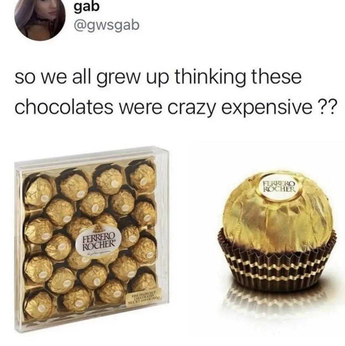 a close up of a box of chocolates next to a chocolate ball