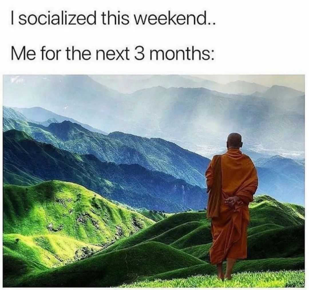 monk standing in front of a mountain with a view of the mountains