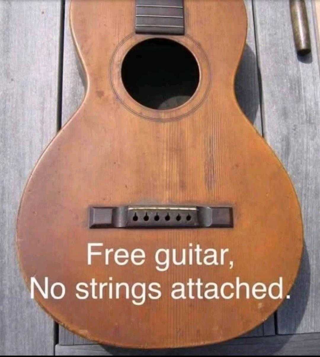 there is a guitar that is sitting on a wooden table