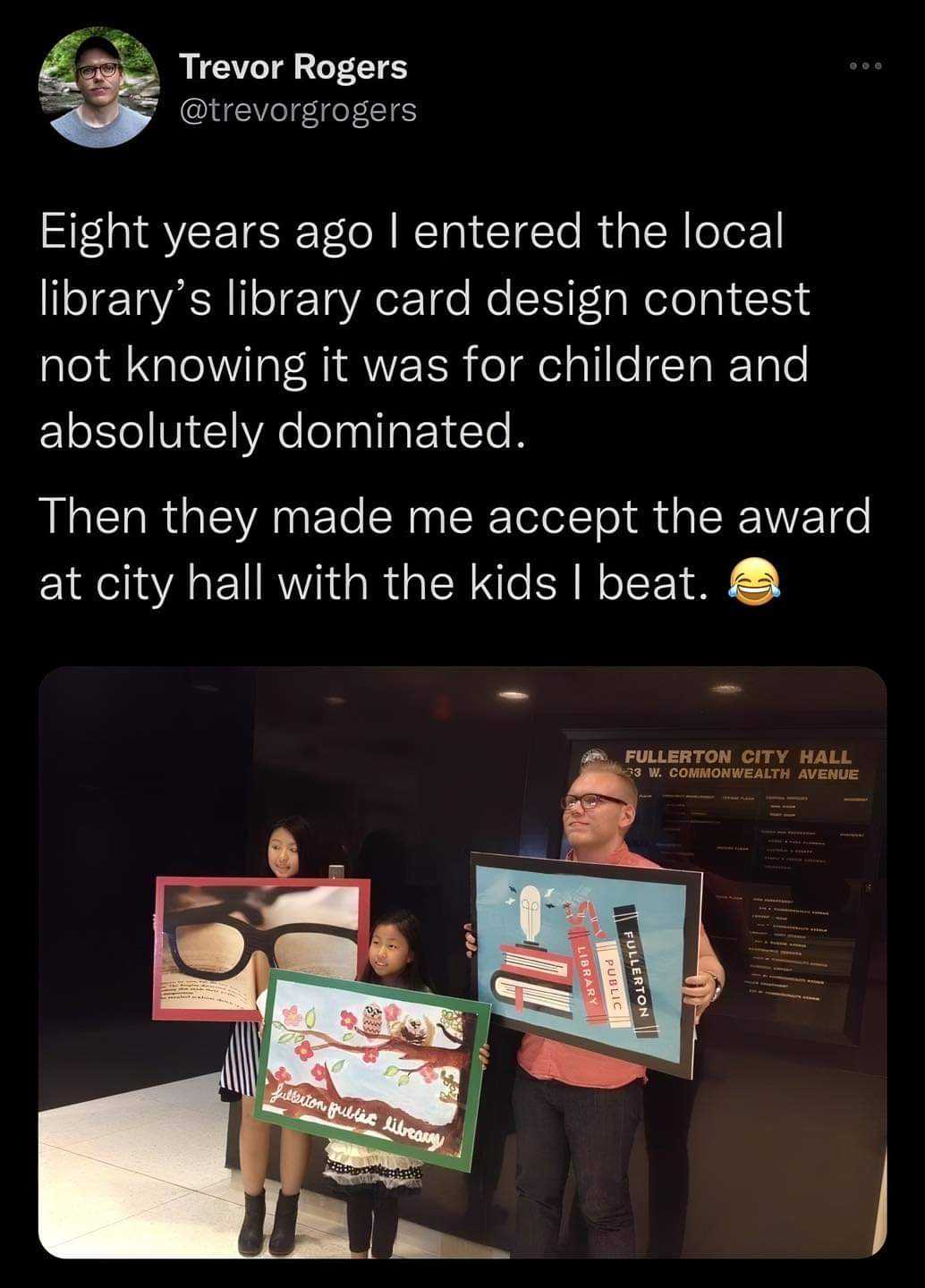 there are two people holding up pictures of a library