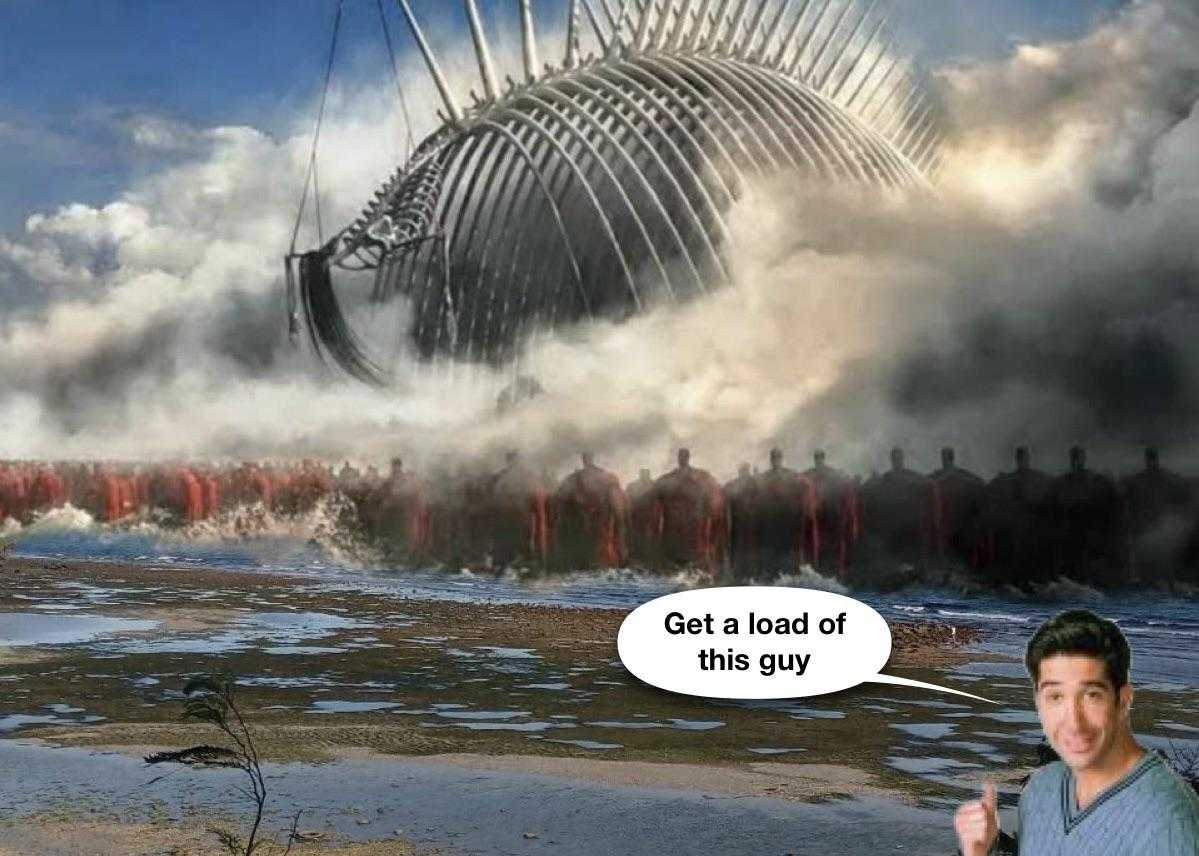 there is a man standing in front of a giant whale