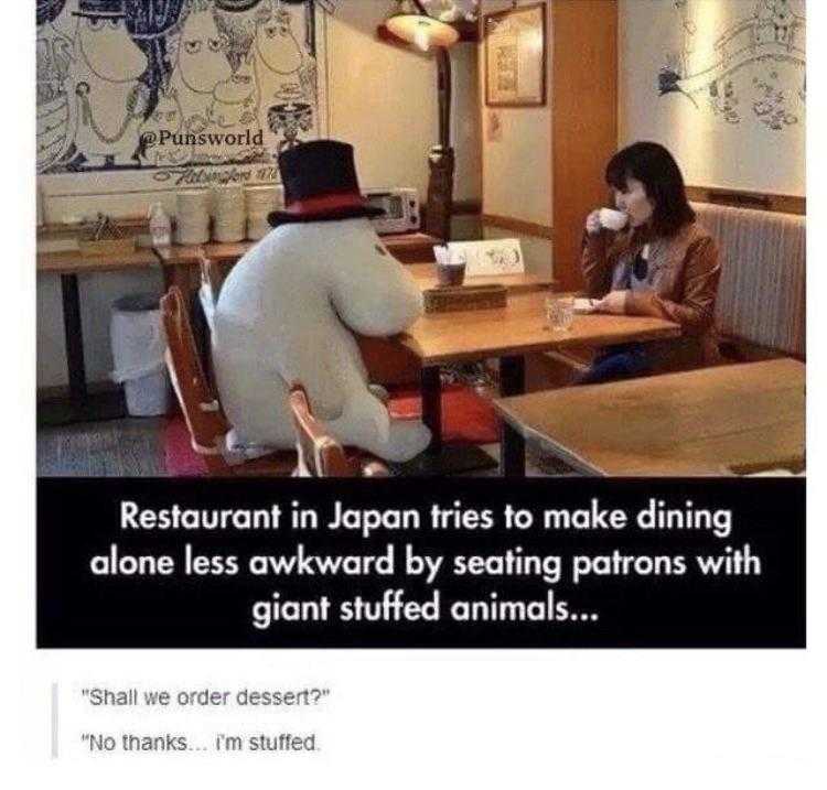 image of a woman sitting at a table with a giant stuffed animal