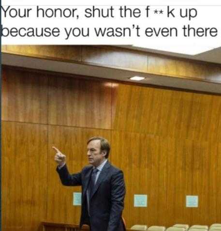 man in a suit and tie standing in front of a podium