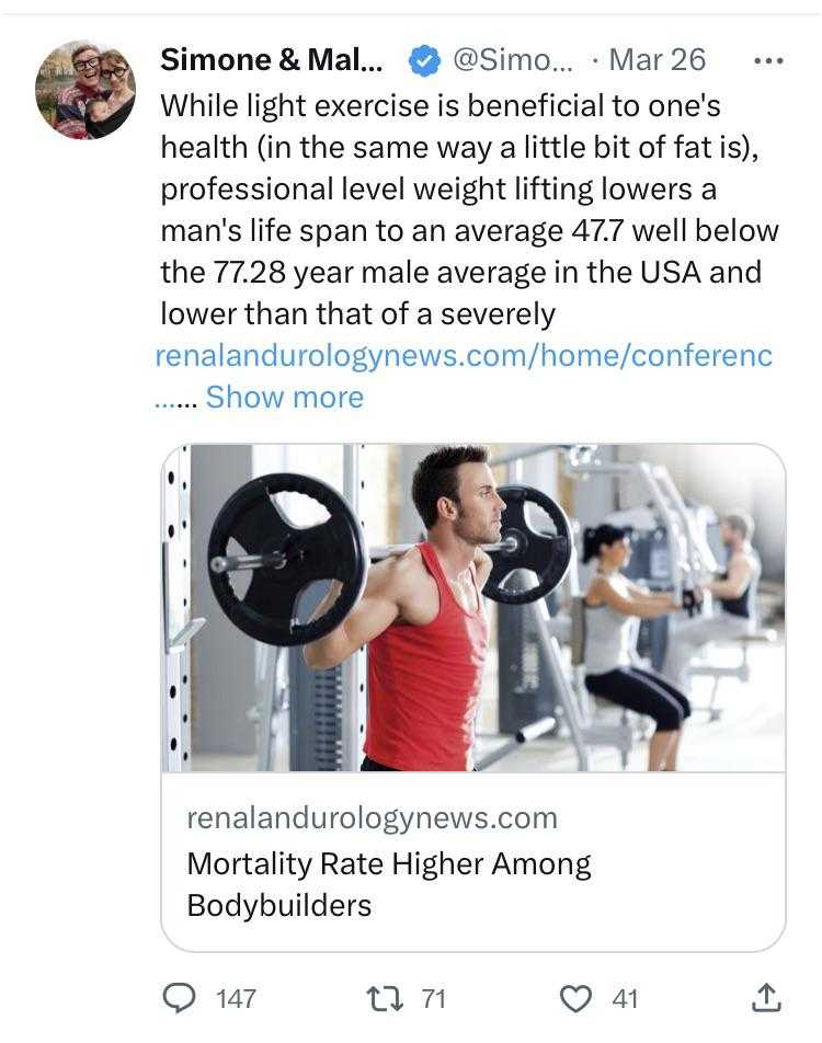 a man is doing a squat with a barbell in a gym