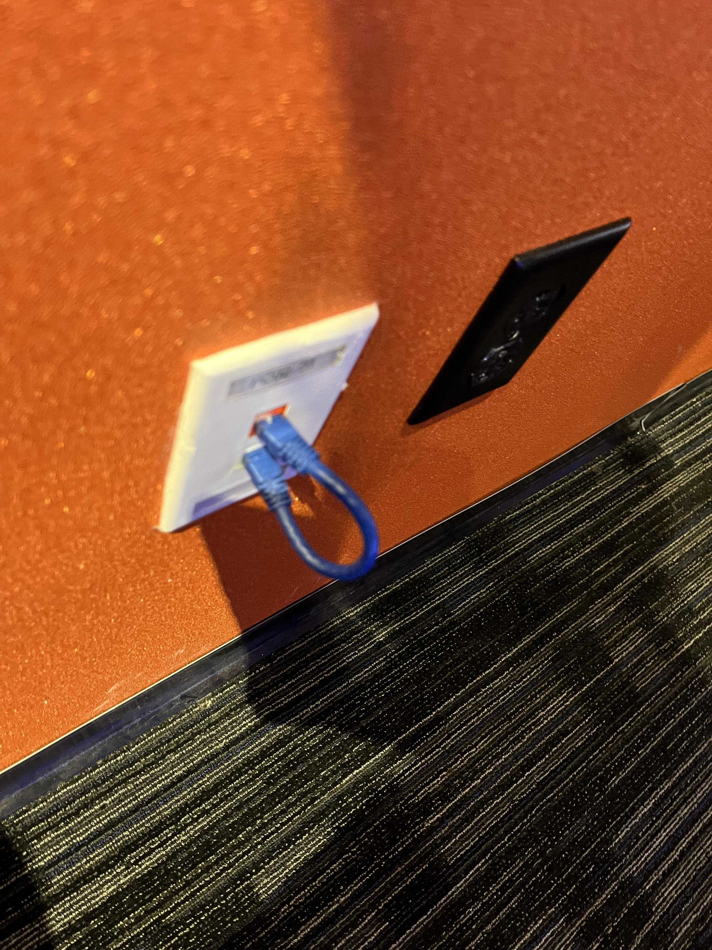 there is a blue pair of scissors sitting on a wall