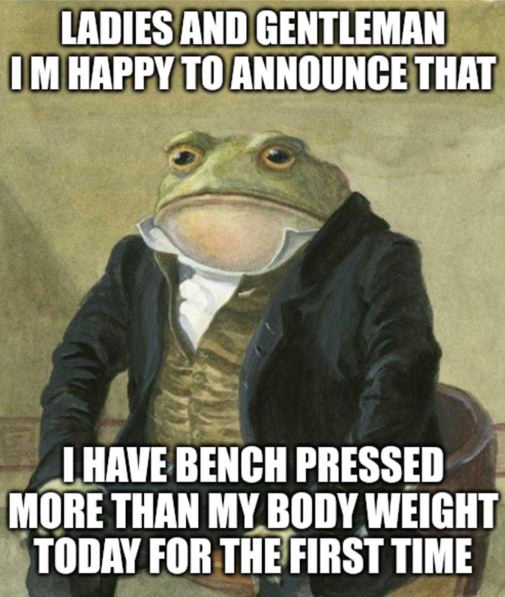 a picture of a frog in a suit sitting on a chair