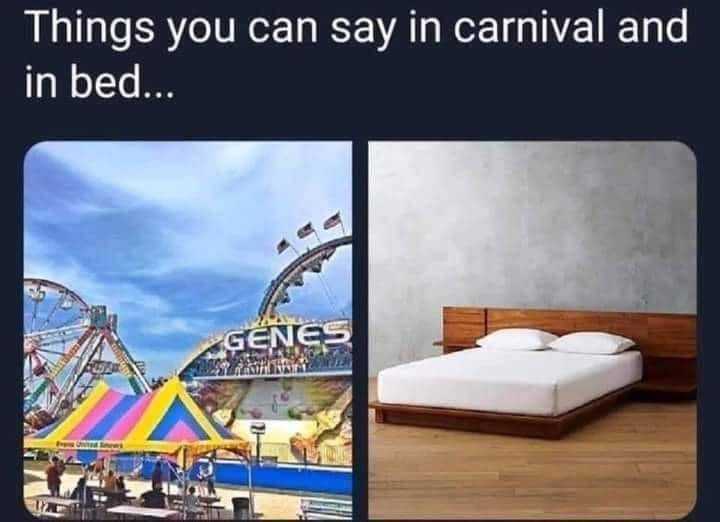 bed with a wooden frame and a picture of a carnival