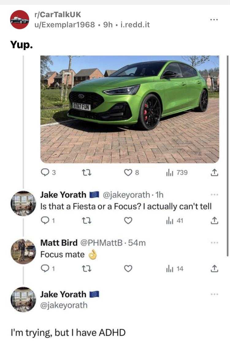 a green ford focus st is parked in a driveway