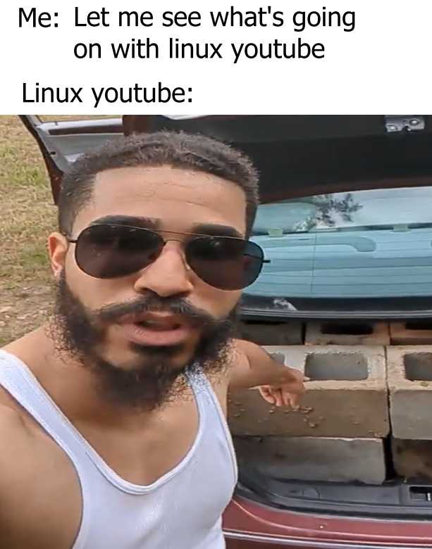 man with a beard and sunglasses standing in front of a car