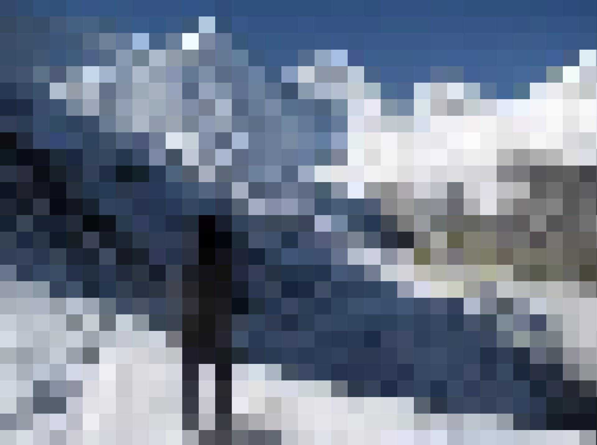 there is a person standing on a snow covered hill with skis