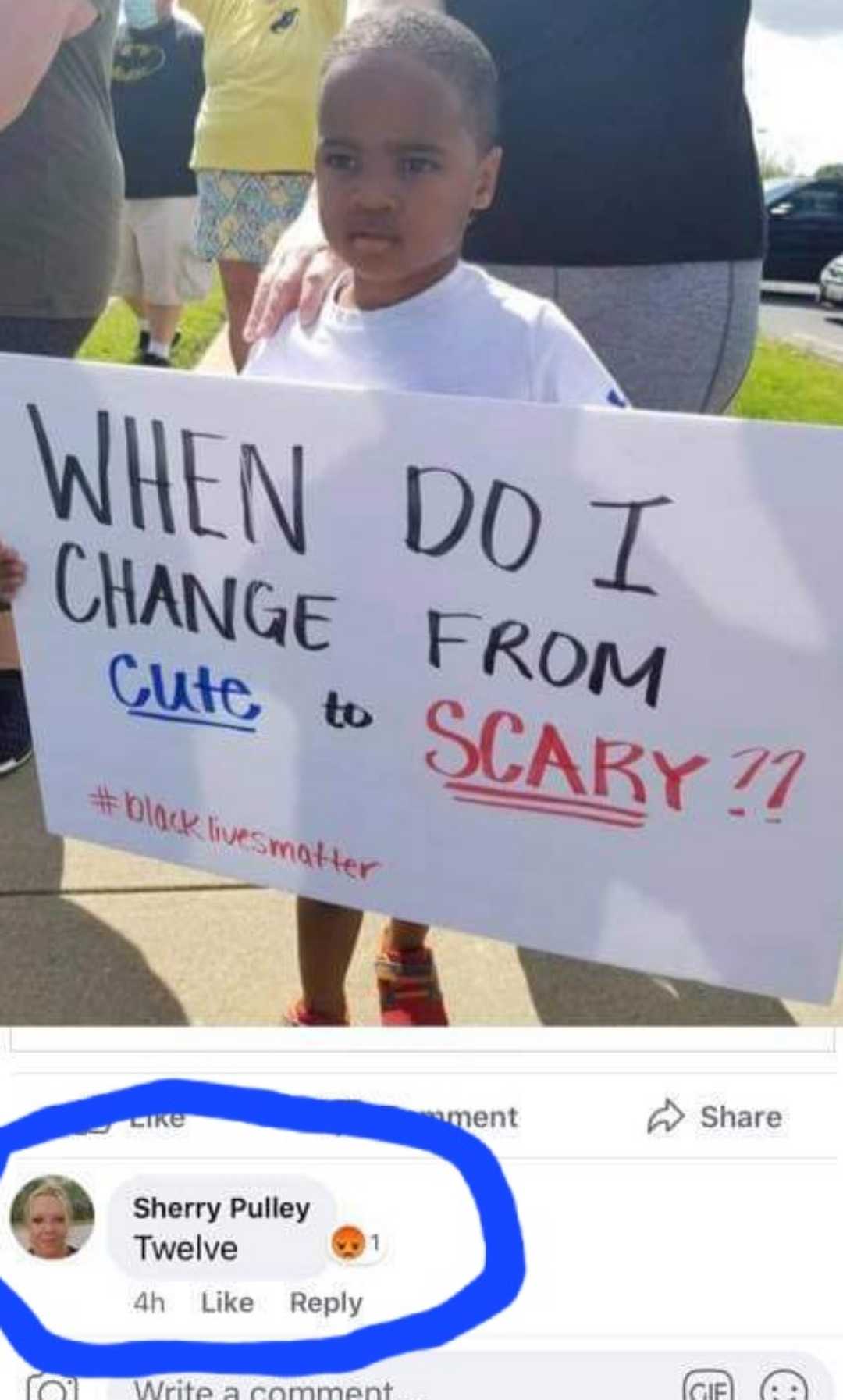 a close up of a child holding a sign with a caption