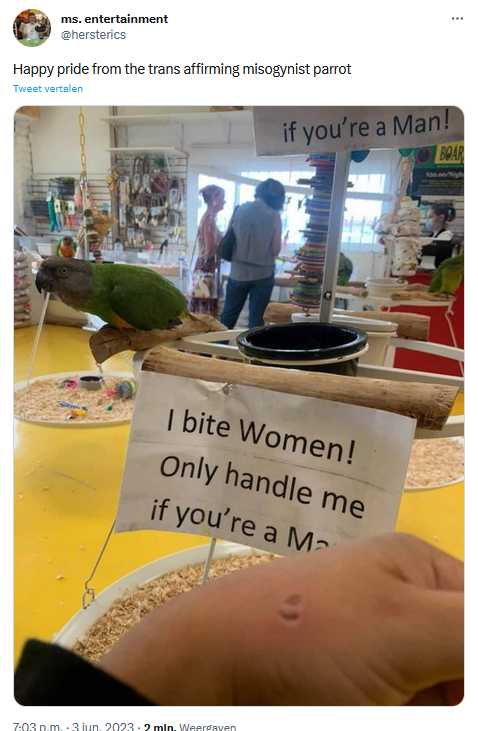 someone posted a sign to a parrot that says, if you ' re a man, bite women only handle me if you ' re a man