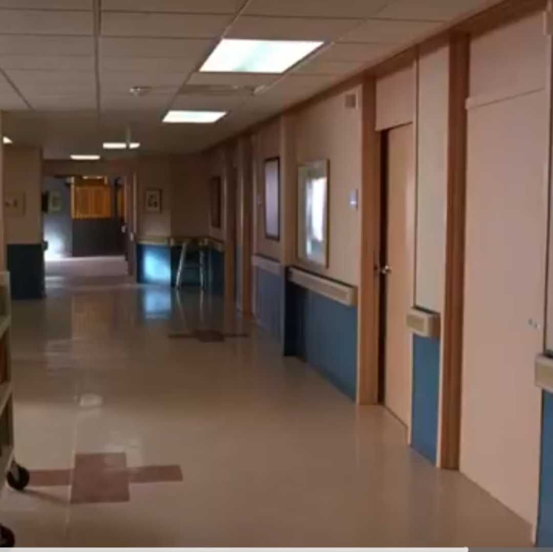 there is a long hallway with a clock on the wall