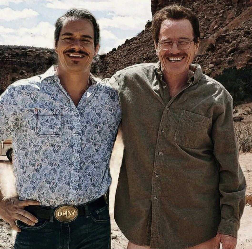 there are two men standing next to each other in the desert