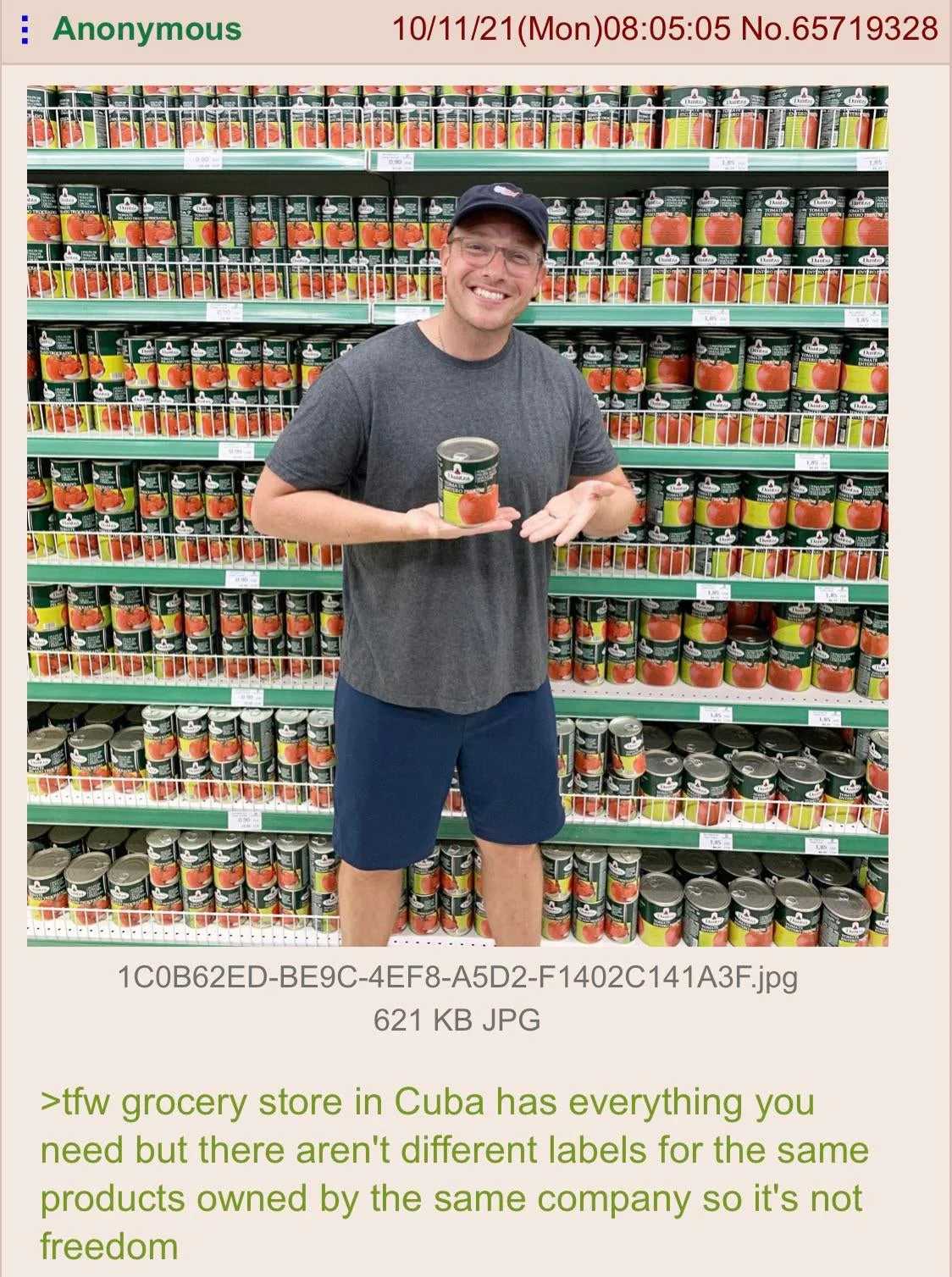 man holding a can of canned food in front of a store shelf