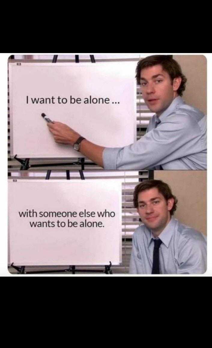 man pointing at a sign with a caption of someone else who wants to be alone