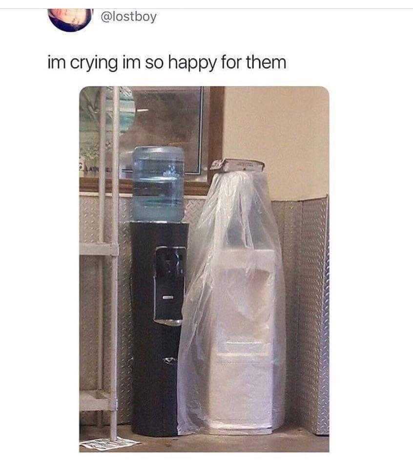 there is a plastic bag sitting next to a water cooler