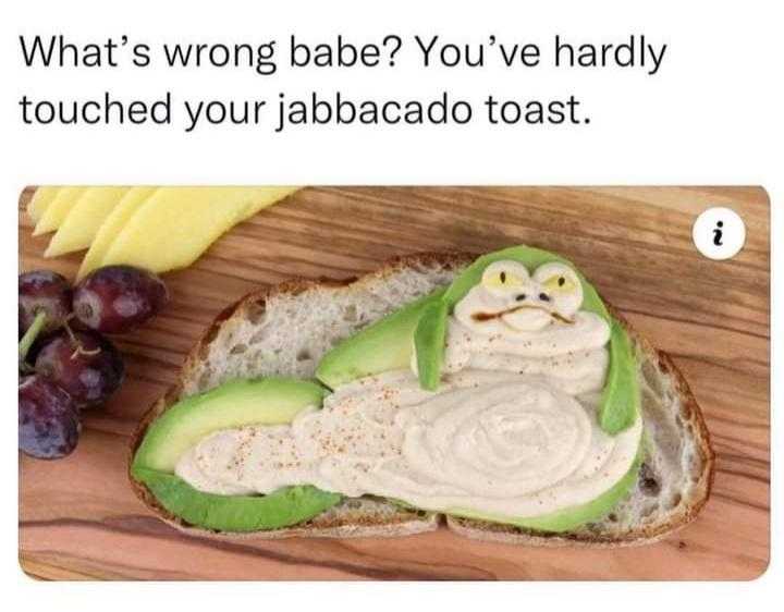 a close up of a sandwich with an avocado on it