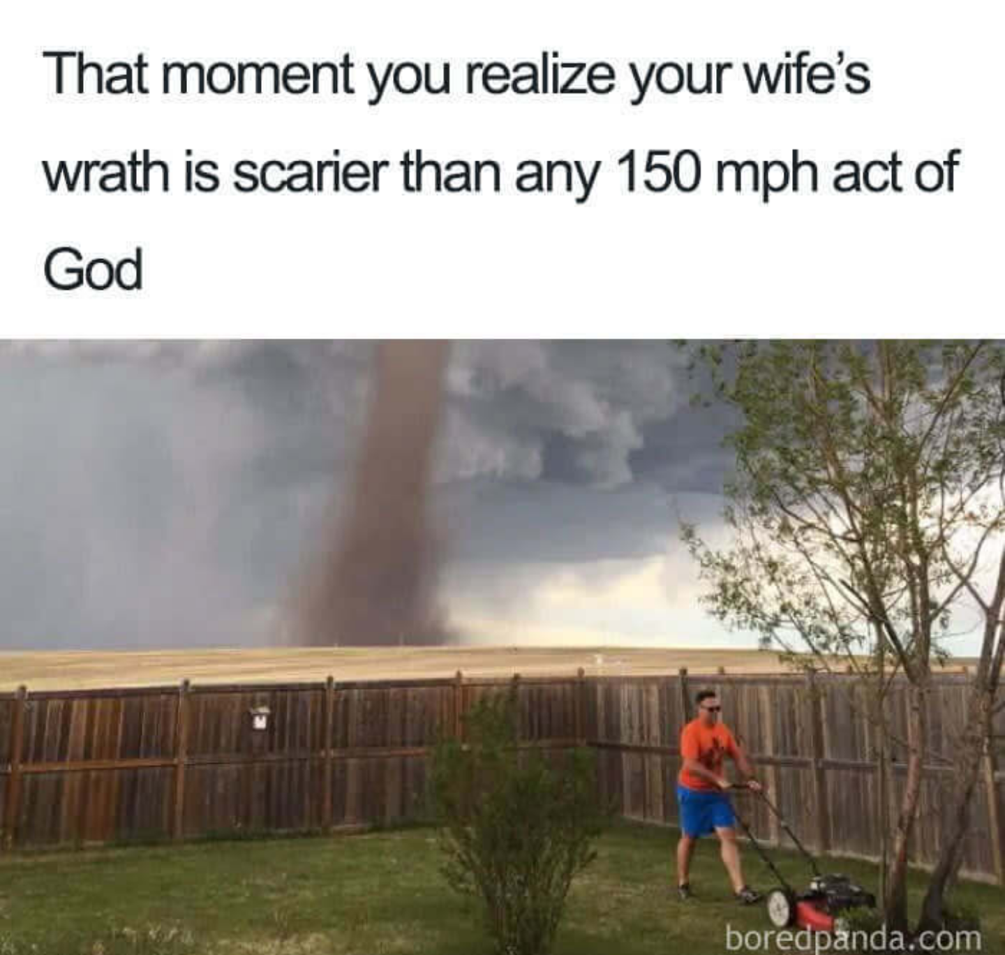 a man mowing a yard with a lawn mower and a tornado in the background