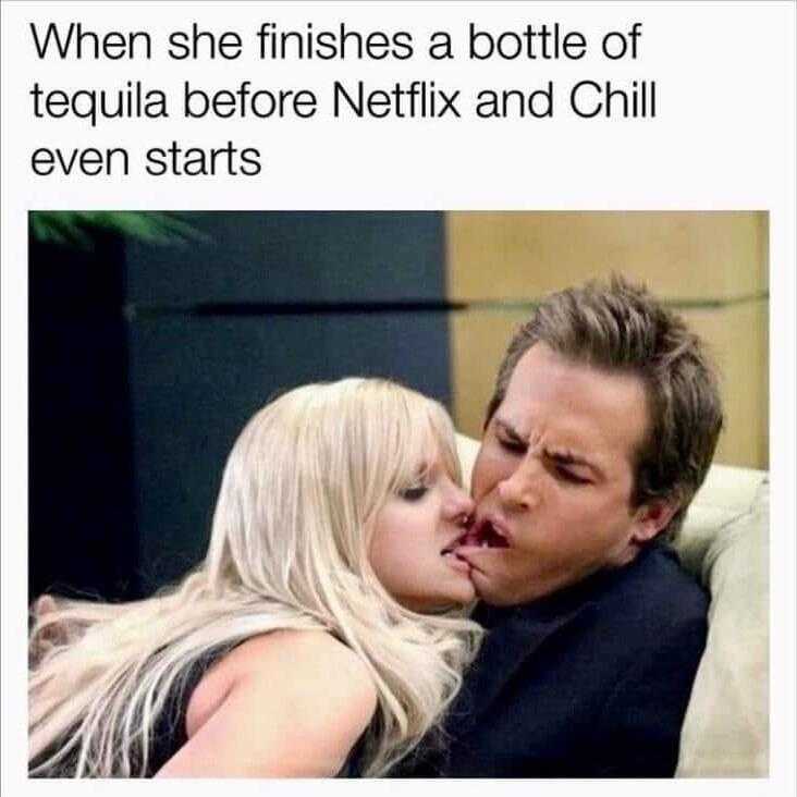 woman kissing a man on the cheek while he finishes a bottle of tequila before netflix and chill even starts