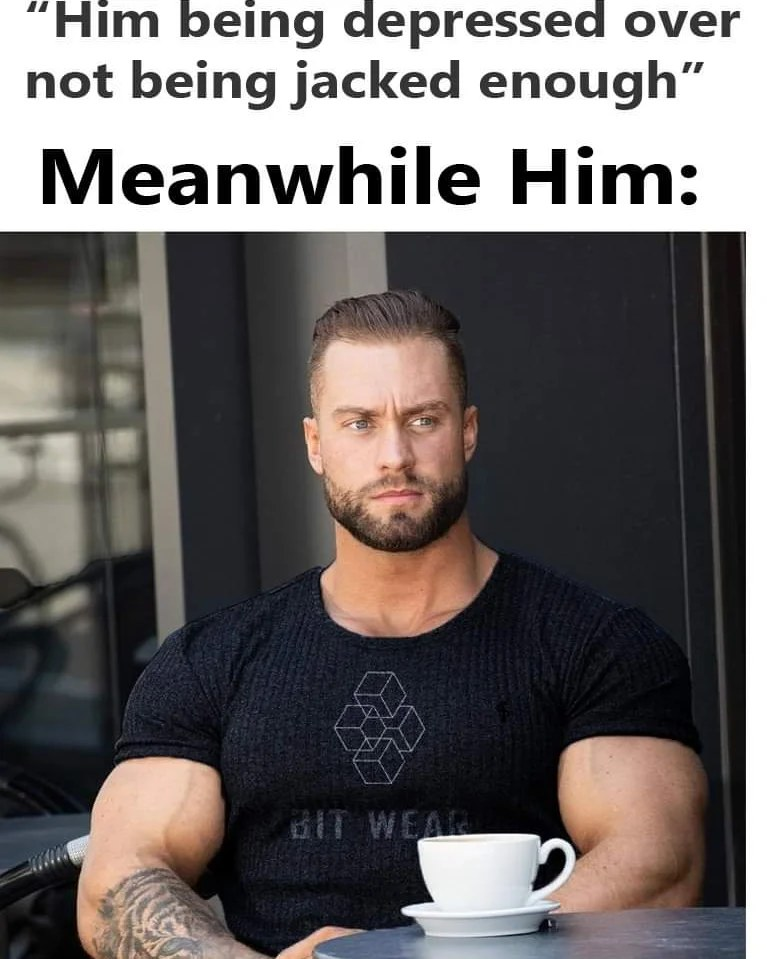 a man with a beard sitting at a table with a cup of coffee