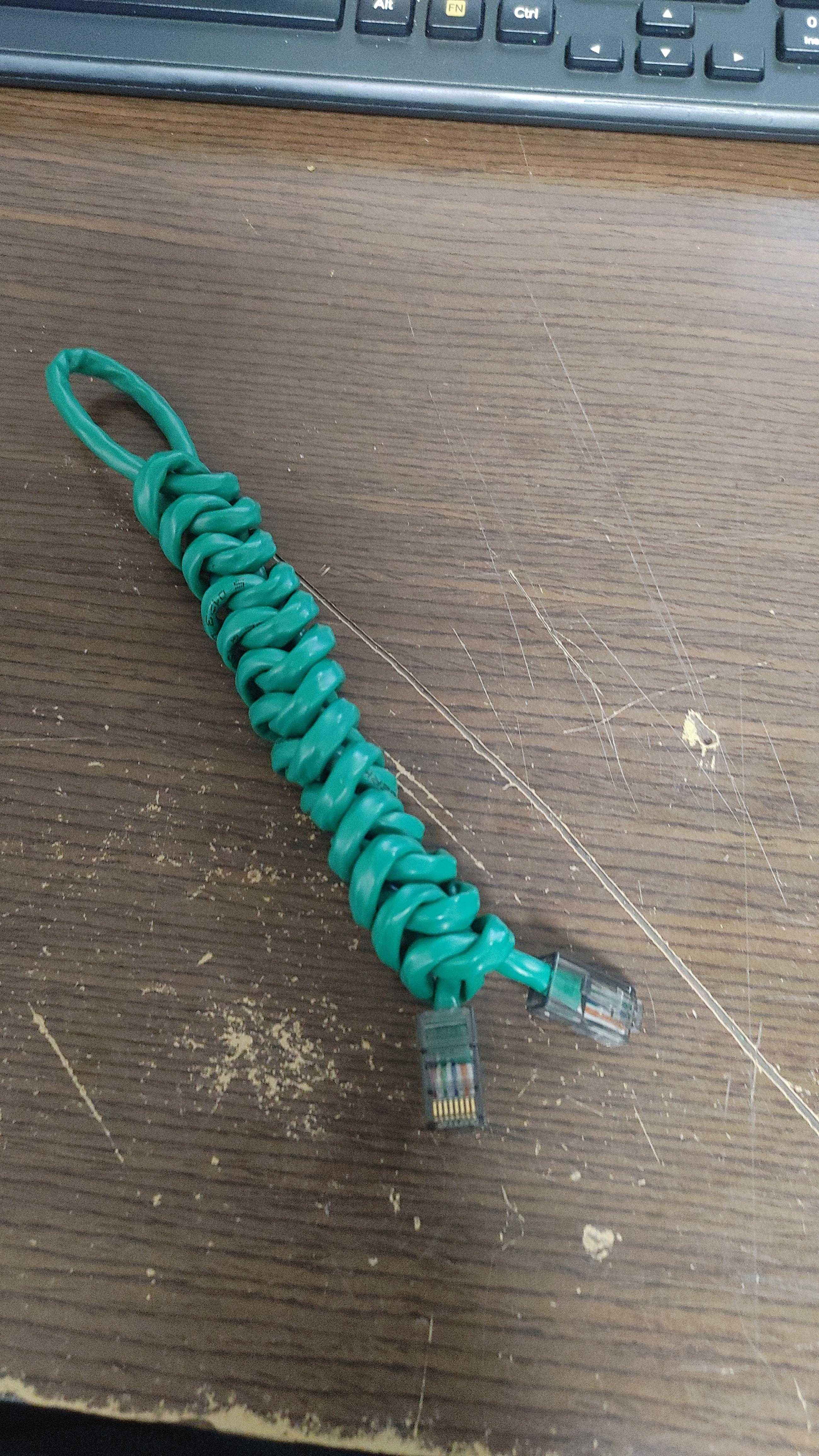 there is a green cord that is connected to a computer keyboard