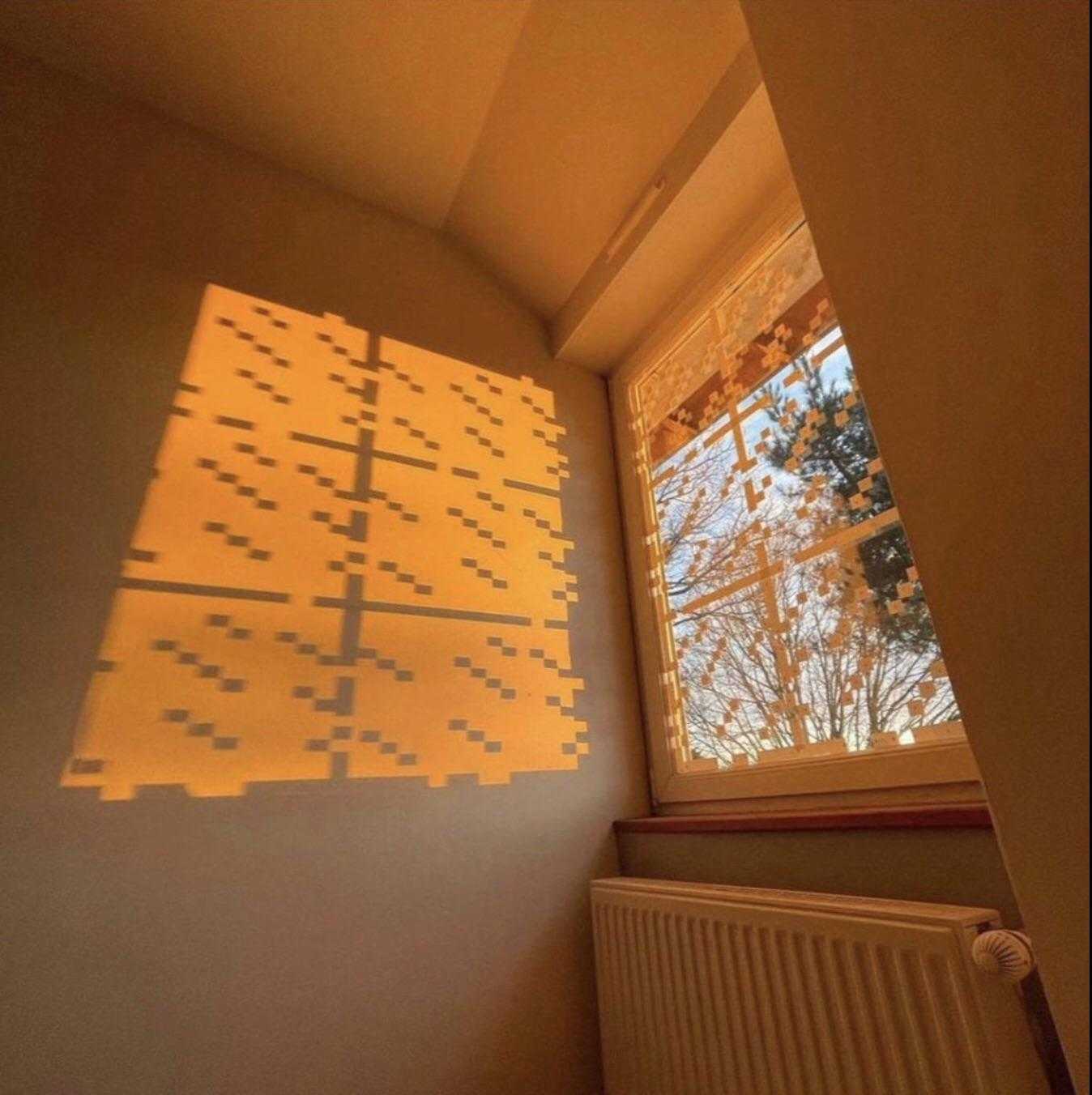 there is a picture of a window with a pattern projected on it