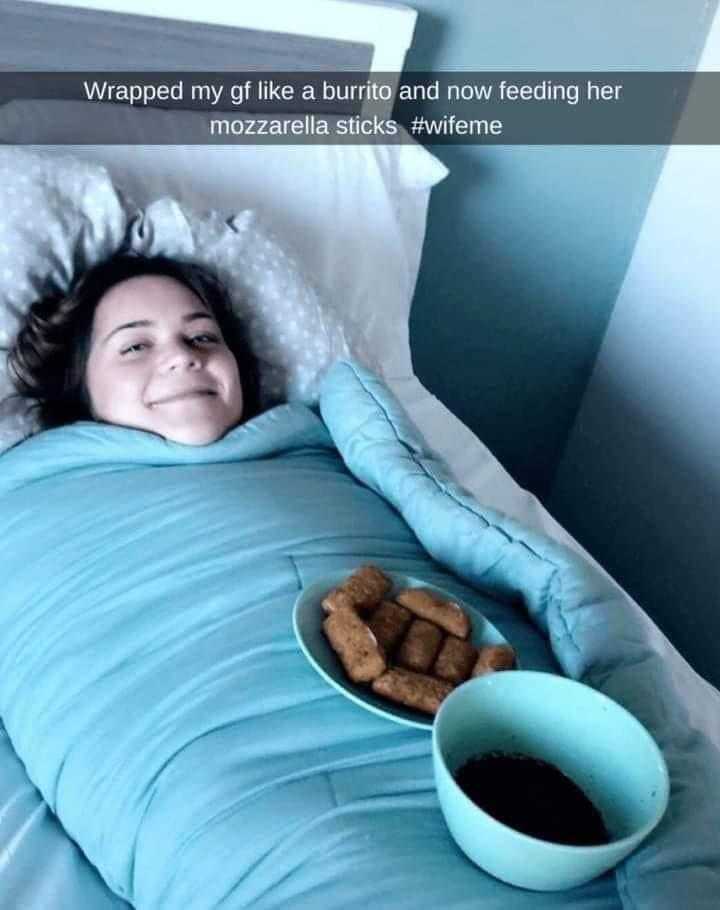 woman laying in bed with a bowl of food and a cup of coffee