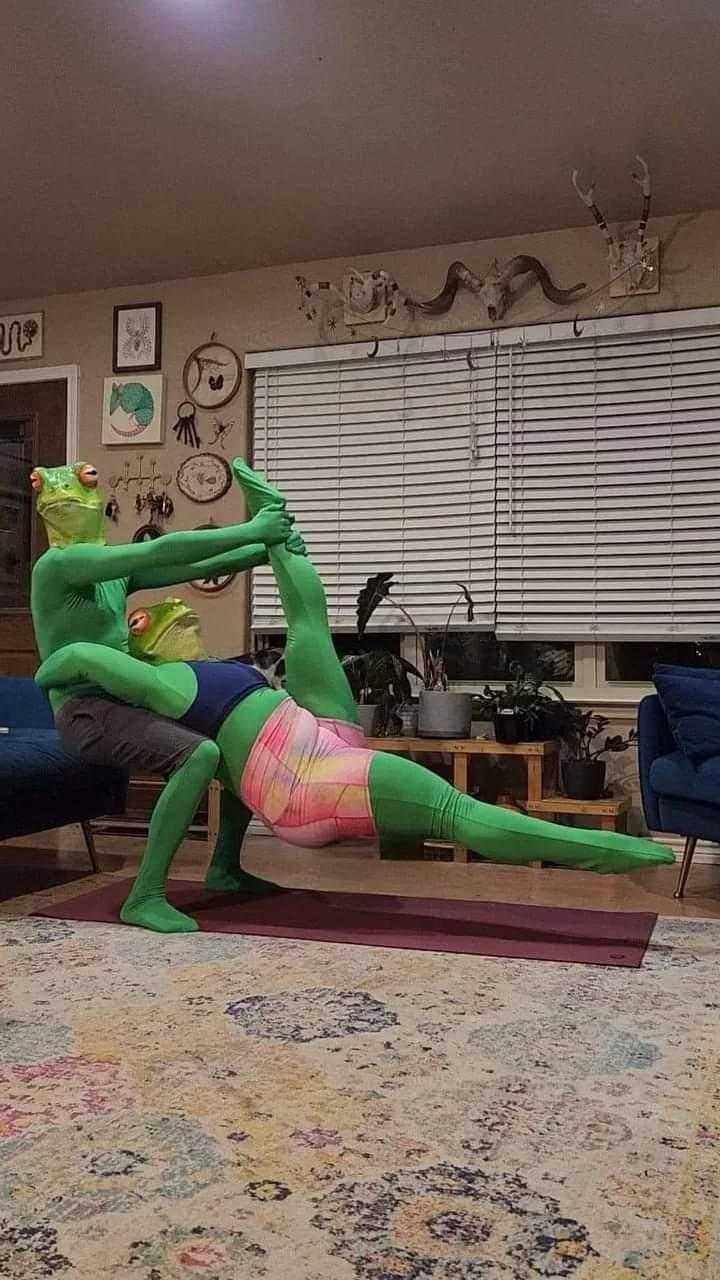 there is a woman in a green costume doing yoga on a mat