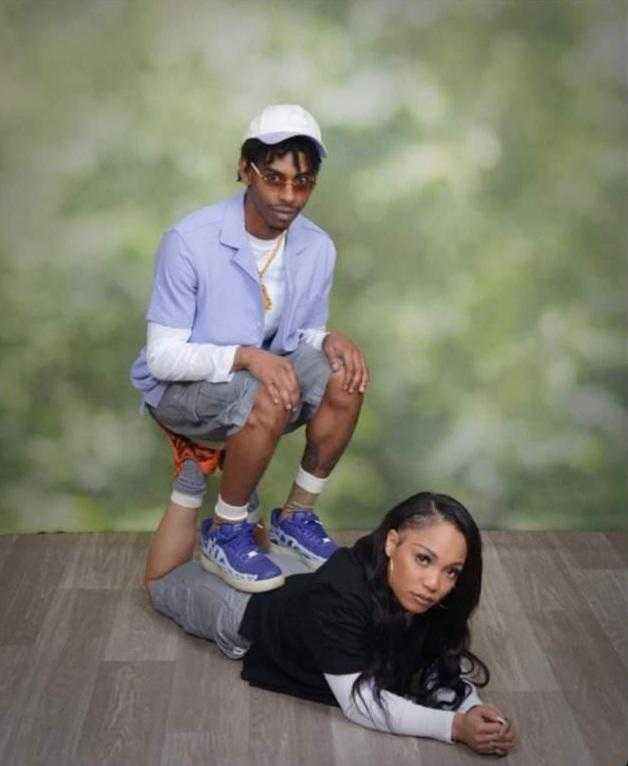 there are two people posing for a picture on the floor