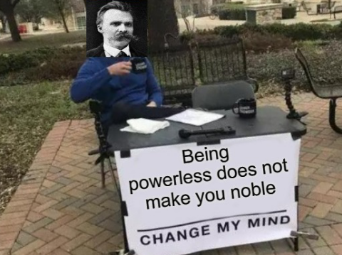 man sitting at a table with a sign that says being powerless does not make you noble change my mind