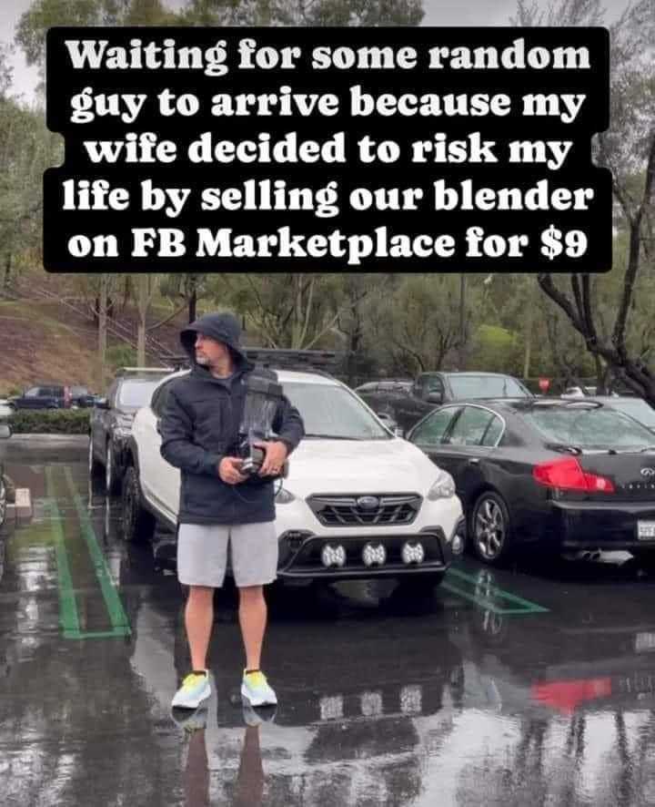 man standing in a parking lot with a car in the background