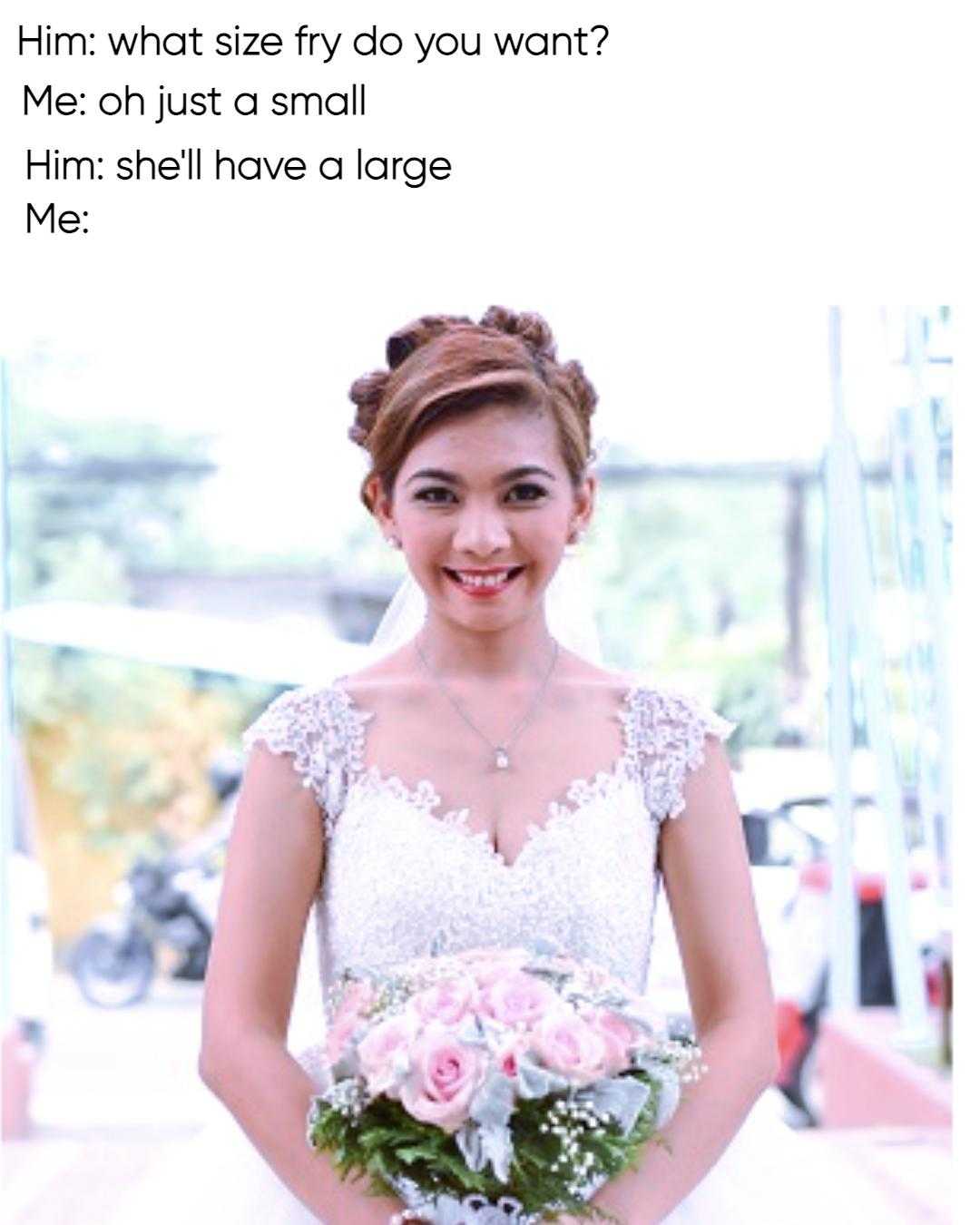 bride in white wedding dress holding bouquet of flowers in front of a building