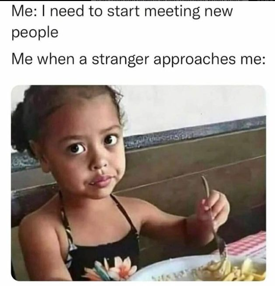 a close up of a child eating food at a table