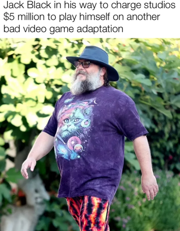 a man with a beard and a hat walking down a street