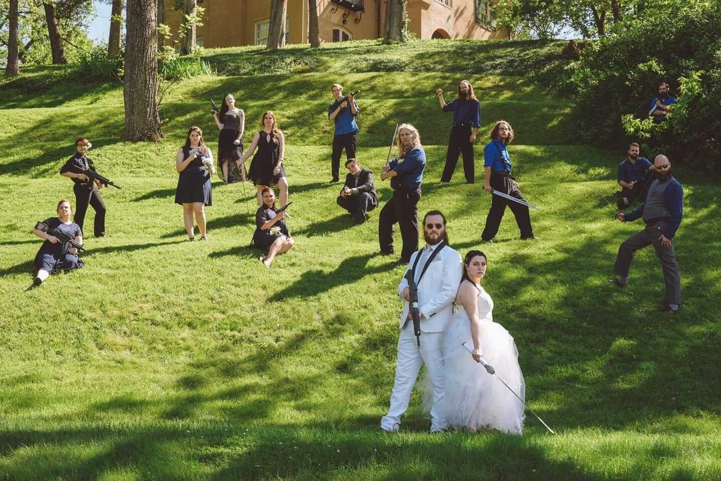 bride and groom posing for a photo with their wedding party