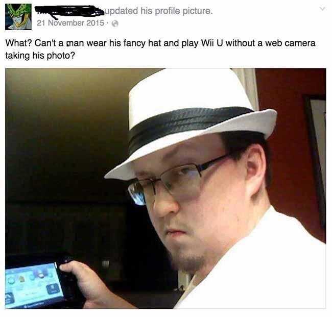 man wearing a white hat and glasses holding a cell phone