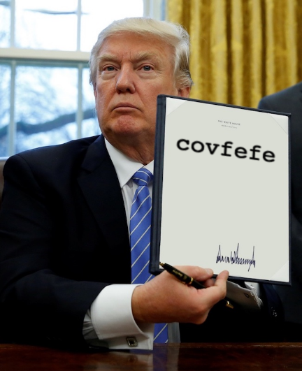 image of a man holding a sign that says covfefe