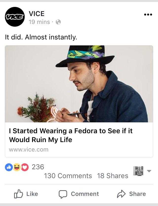 a close up of a person wearing a fedora and a hat